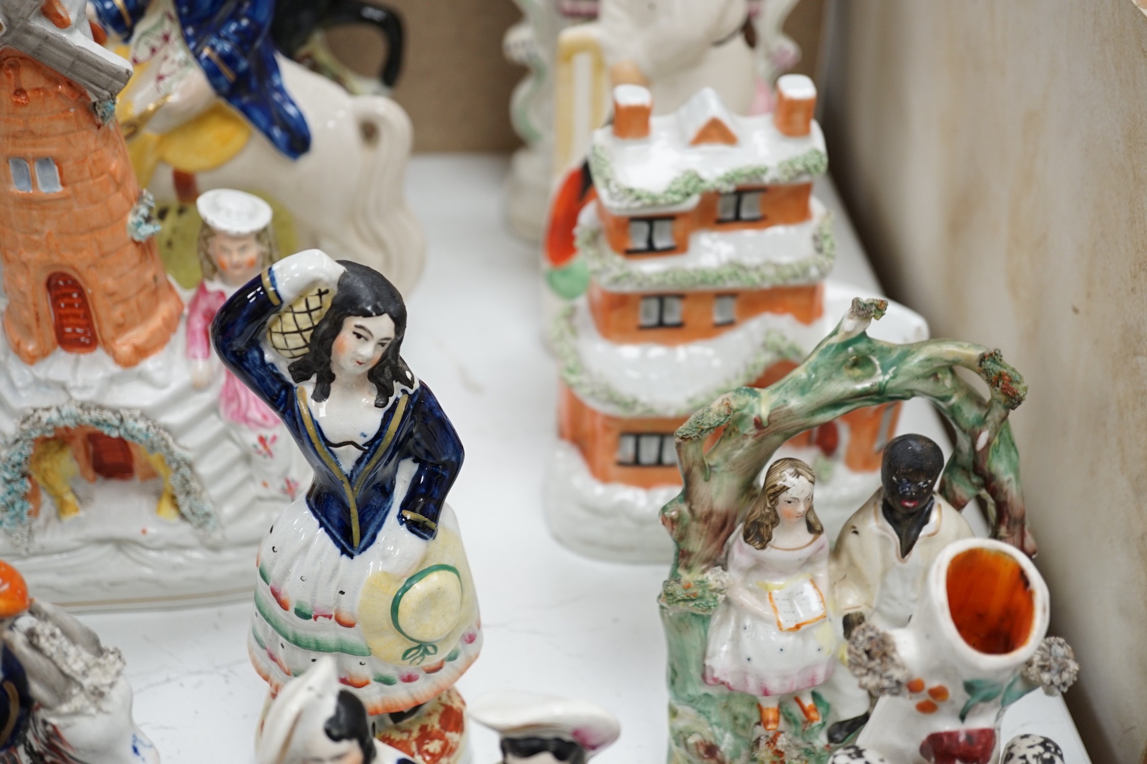 A collection of Victorian Staffordshire pottery flat-back figures and groups, tallest 29cm